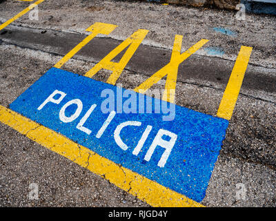 Yellow Taxi and blue Policia parking signs on the asphalt in the spanish city of Palma de Mallorca   Stock Photo