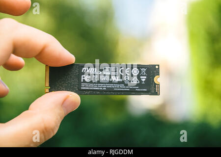 PARIS, FRANCE - JUL 27, 2018: Man hand holding new Samsung 870 Pro NVME PCIE SSD hard drive disk with high read and write speed Samsung 870 Pro - holding rear side Stock Photo
