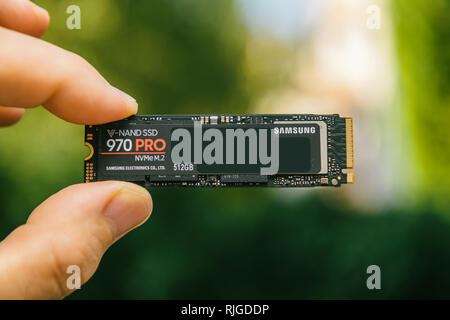 PARIS, FRANCE - JUL 27, 2018: Macro shot of man hand holding new Samsung 870 Pro NVME PCIE SSD hard drive disk with high read and write speed Samsung 870 Pro Stock Photo