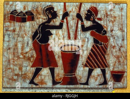 Women grinding corn; Batik, from Upper Volta (Burkina Fasso), West Africa. 1970 Stock Photo