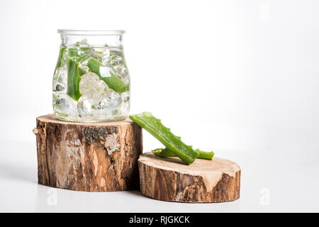 Studio shot of glass jar with ice cubes and aloe vera leaves Stock Photo