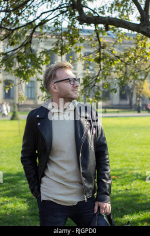 Smart smiling guy in casual clothes, looking left Stock Photo