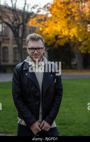 Smart smiling guy in casual clothes, looking straight Stock Photo