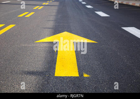 Arrow mark on asphalt , showing the highway traffic direction. Stock Photo