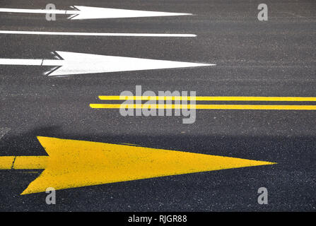 Arrow mark on asphalt , showing the highway traffic direction. Stock Photo
