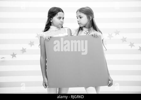 Disappointing news. Girl hold announcement banner. Girls kids holding paper banner for announcement. Children sad with blank paper announcement copy space. Kids announcement concept. Stock Photo