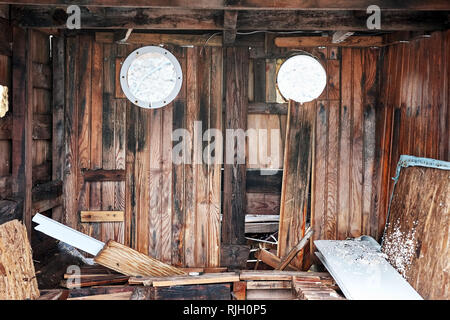 Interior of an abandoned wreckage wooden boat cabin after a sea accident disaster Stock Photo