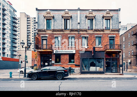 Montreal, Canada - June, 2018: Old grunge victorian style brick building on saint denis street in Montreal, Quebec, Canada. Editorial. Stock Photo