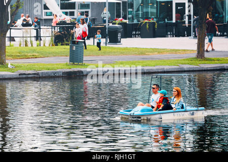 Montreal, Canada - June, 2018: Canadian family cruising on a pedalo boat on the pond in old port, Montreal, Quebec, Canada. Editorial. Stock Photo