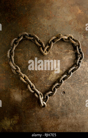 Rusty chain in heart shape Stock Photo