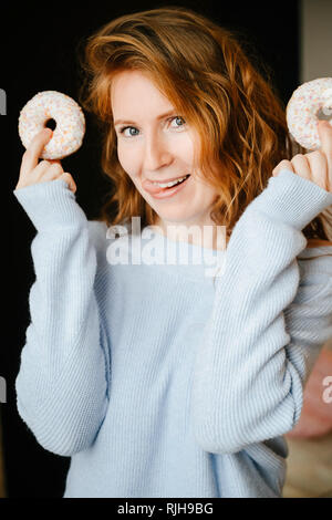 Portrait of a redhead girl and donuts.  Stock Photo