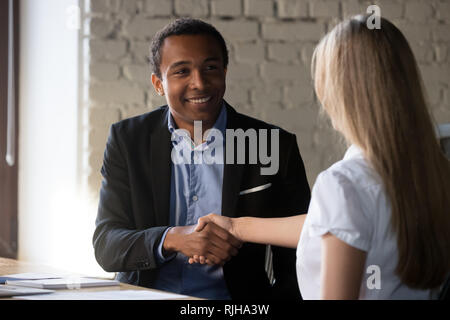 Excited partners handshake after successful interview in office Stock Photo