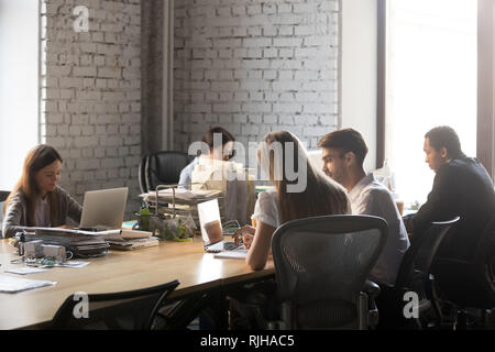 Diverse employees busy working in shared office Stock Photo