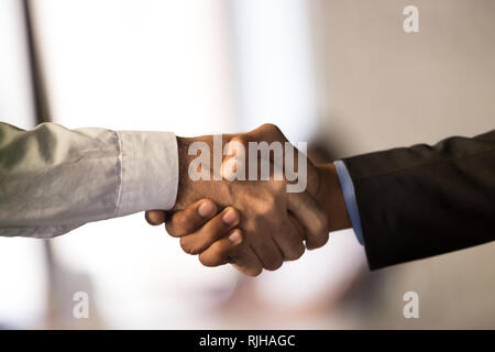 Close up of male employees handshake closing deal Stock Photo