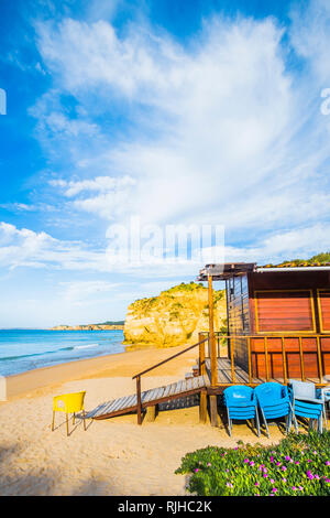 wooden beach hut and chairs on deserted beach in pre-season Stock Photo
