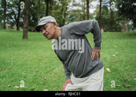 asian senior old man having back pain Stock Photo