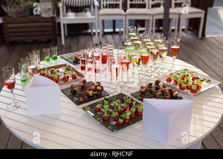 catering services background with snacks and colorful drinks on white table Stock Photo