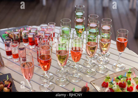 catering services background with snacks and colorful drinks on white table Stock Photo