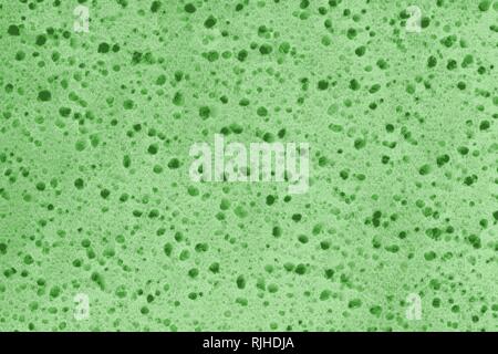 Green spongy texture of a rubber sponge or insulation foam Stock Photo
