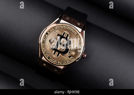 Bitcoin time concept on creative background.. Golden Bitcoin over the watch . Time cryptocurrency concept . Stock Photo