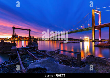 View from riverside of illuminated bridge at sunset, Gothenburg, Sweden, Europe Stock Photo