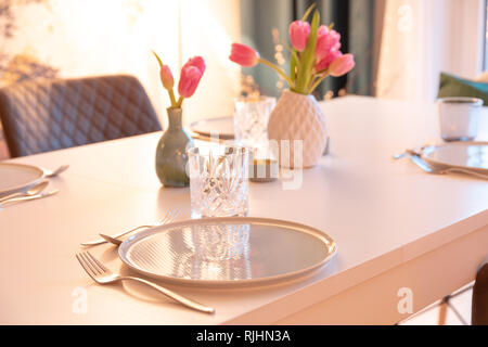 Decorated tabel with Plates and Tulips Stock Photo