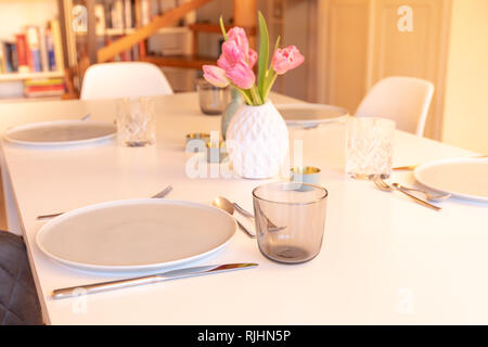 Decorated tabel with Plates and Tulips Stock Photo