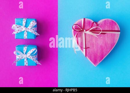 Gift boxes over pink and blue backdrop. Valentines day background Stock Photo