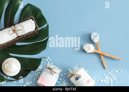 Composition of spa items on a color blue background with a tropical leaf, the concept of body care and spa treatments Stock Photo