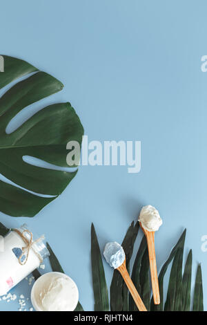 Composition of spa items on a color blue background with a tropical leaf, the concept of body care and spa treatments Stock Photo