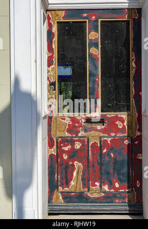 Stripped back wooden door with street light shadow Stock Photo