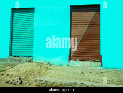 Egyptian muddy Street with Closed storage doors on a bright turquise background. Stock Image. Stock Photo