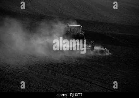 Tractor during autumn work in the fields of South Moravia at sunset Stock Photo