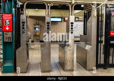 Automatic access control ticket barriers in subway station with signs of entry and exit in New York City, USA Stock Photo