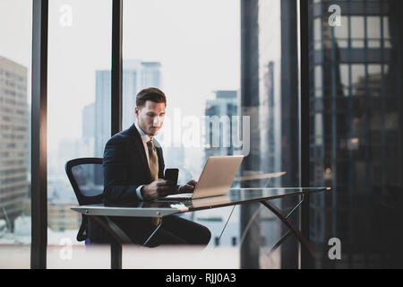 Businessman working in executive office in a skyscraper Stock Photo