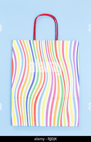 Colorful paper bag on blue background Stock Photo