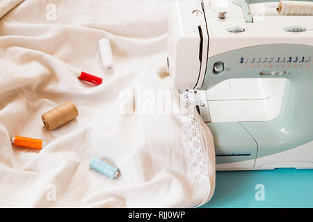 Sewing machine with lace, cotton and threads Stock Photo