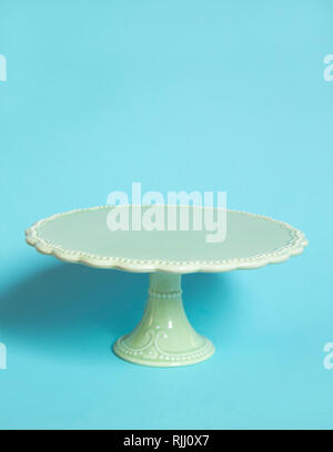 Vintage cake stand on blue background Stock Photo
