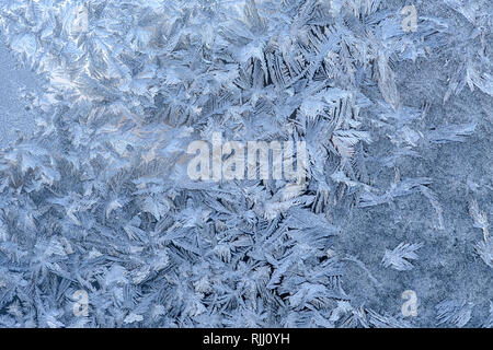 Winter frost pattern  on a glass window pane Stock Photo