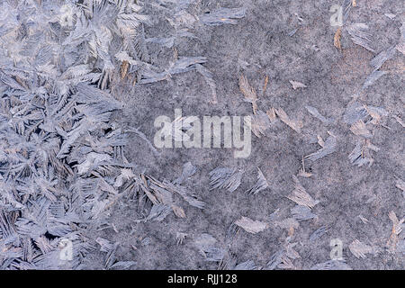 Winter frost pattern  on a glass window pane Stock Photo