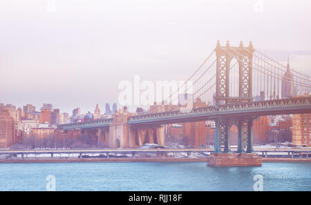 View of the Manhattan Bridge on a winter foggy day in New York, USA
