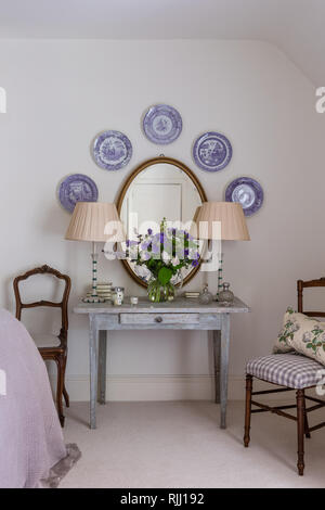 Antique Wedgwood plates displayed above old wooden table Stock Photo