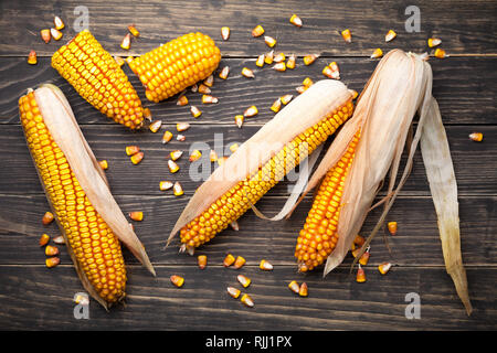 Corn cobs and seeds on wooden table. Top view Stock Photo