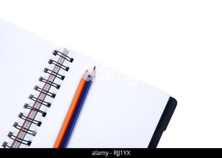 Color Pencils On An Open Book Isolated On White Stock Photo
