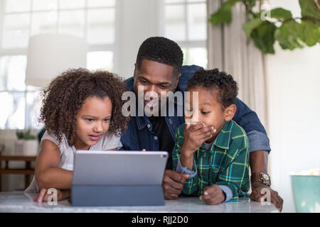 African American family using digital tablet together Stock Photo