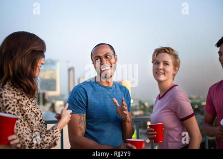 Group of friends dancing at a rooftop party Stock Photo