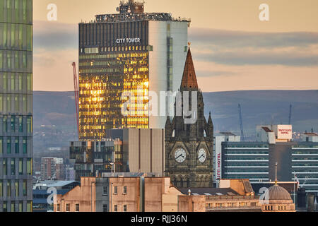 Manchester city centre skyline view across the rooftops from Salford from Wilburn, Town hall clock tower at City Tower Stock Photo