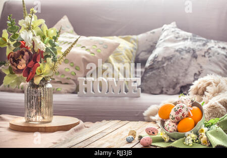 Easter breakfast in a homely interior with a vase of flowers and wooden letters home, concept of Holidays and home comfort Stock Photo