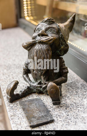 Pomagajek, one of the brass gnomes (krasnale, krasnoludki) in Wrocław, Wroklaw, Poland Stock Photo
