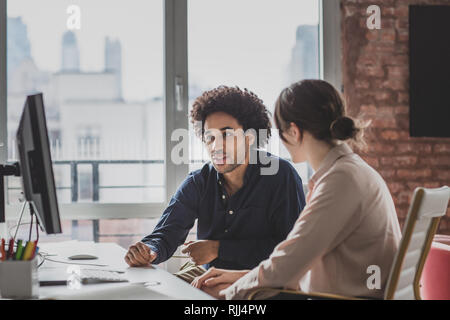 Coworkers working together in an office Stock Photo